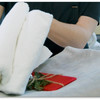 Eine Person faltet zwei weiße Handtücher