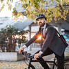 Mann im Anzug sitzt auf einem Fahrrad