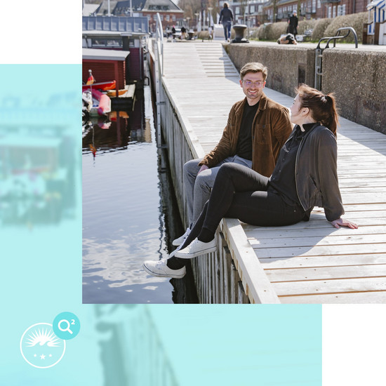 Zwei Personen sitzen am Flensburger Hafen