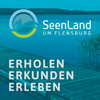 Ein Steg am See mit dem Logo vom Seeland als overlay