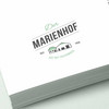 Der Marienhof Logo auf weißem Papier