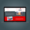 Laptop mit grau-roter Website von DGN vor grauem Hintergrund